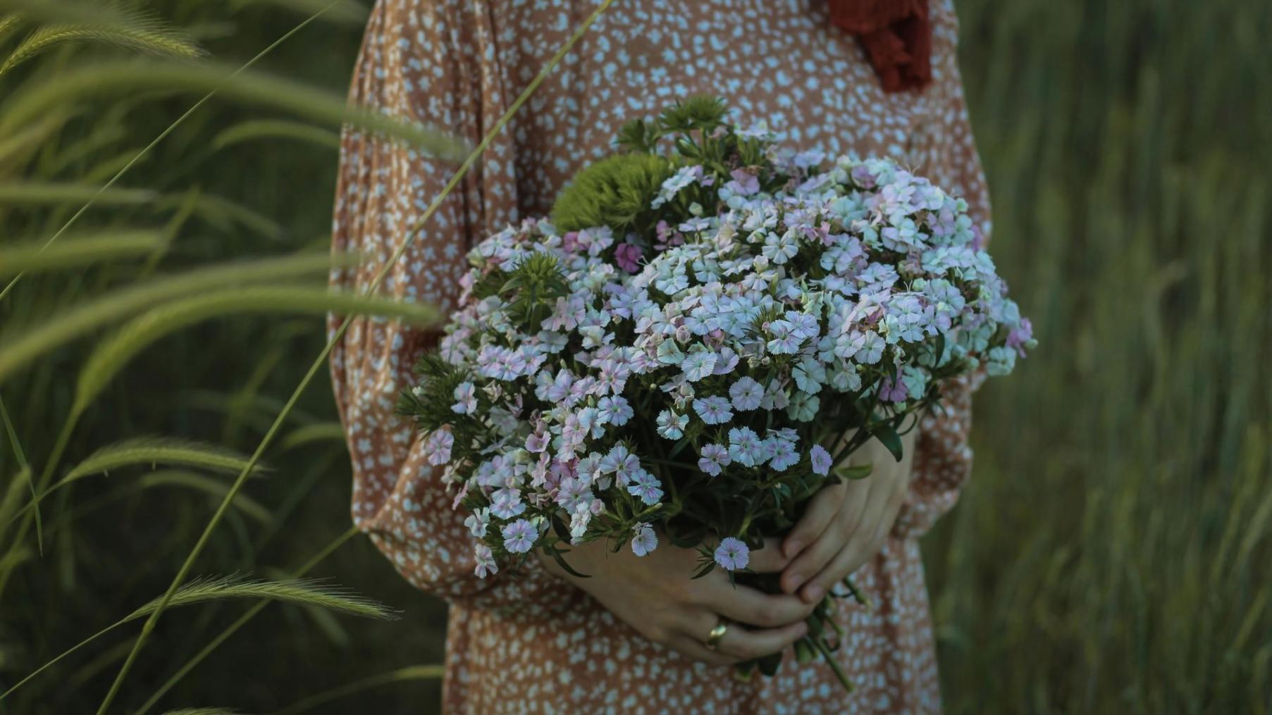 Detailaufnahme einer floralen Hochzeitsdekoration mit Rosen und Schleierkraut in Pastellfarben